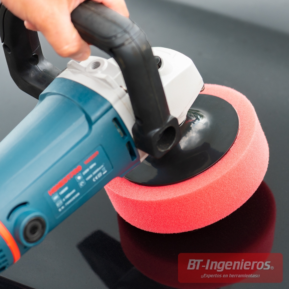 Pulidora eléctrica utilizando esponja de corte roja sobre superficie negra
